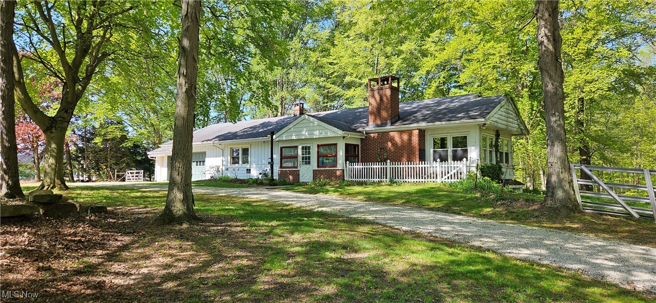 7836 Beach Road Wadsworth, OH 44281 - Photo 2 of 22 View of front facade featuring an attached garage, enclosed front porch, and circular driveway