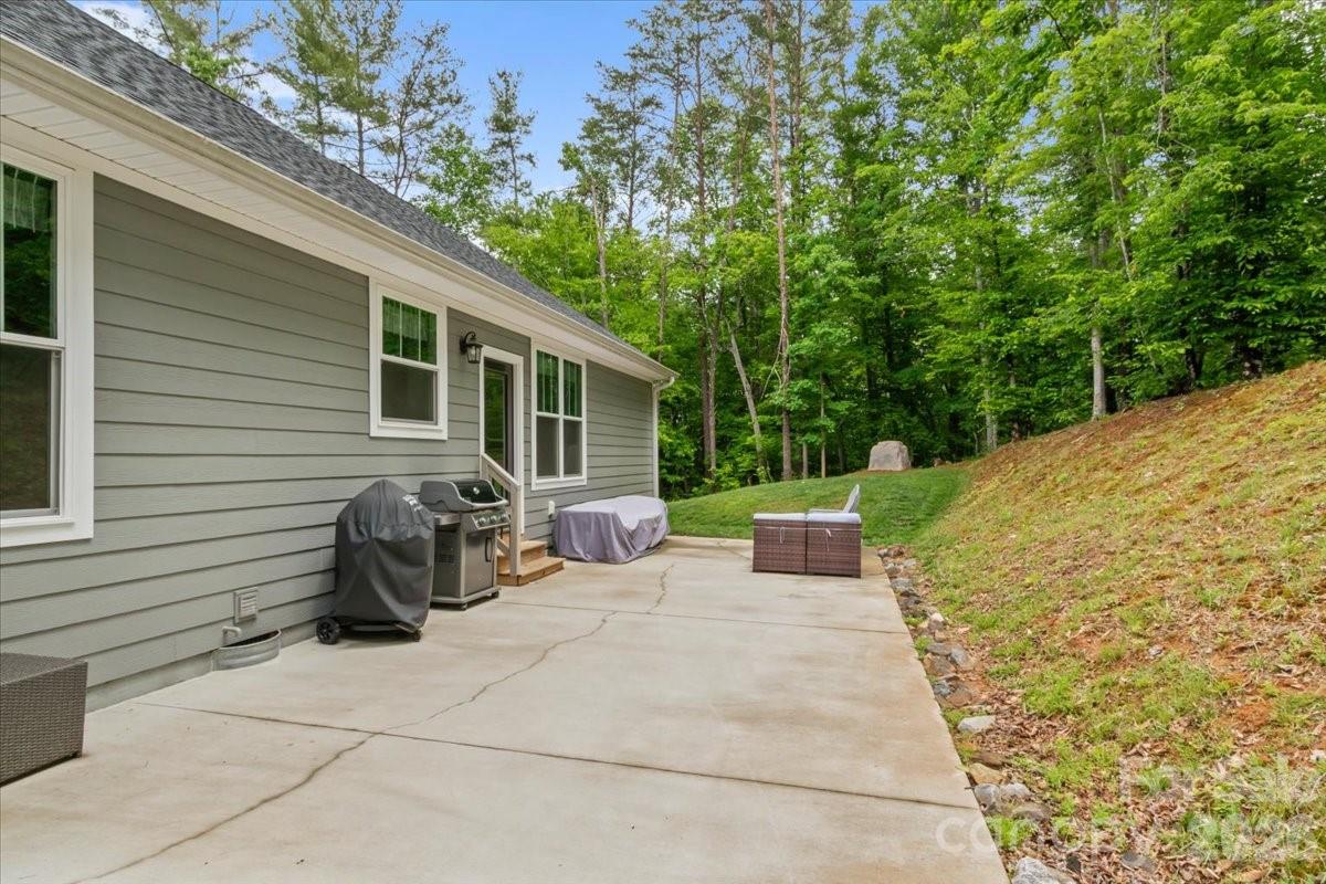 36 Cherry Ridge Lane Weaverville, NC 28787 - Photo 30 of 37 a view of a patio with table and chairs and wooden fence