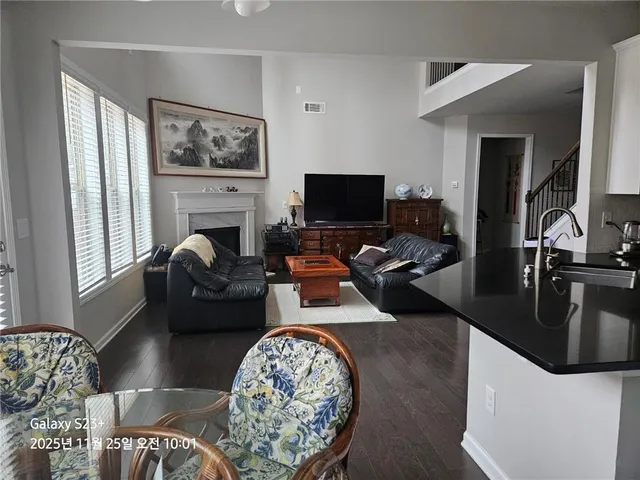 a living room with furniture flat screen tv and a fireplace