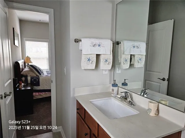a bathroom with a sink vanity and mirror