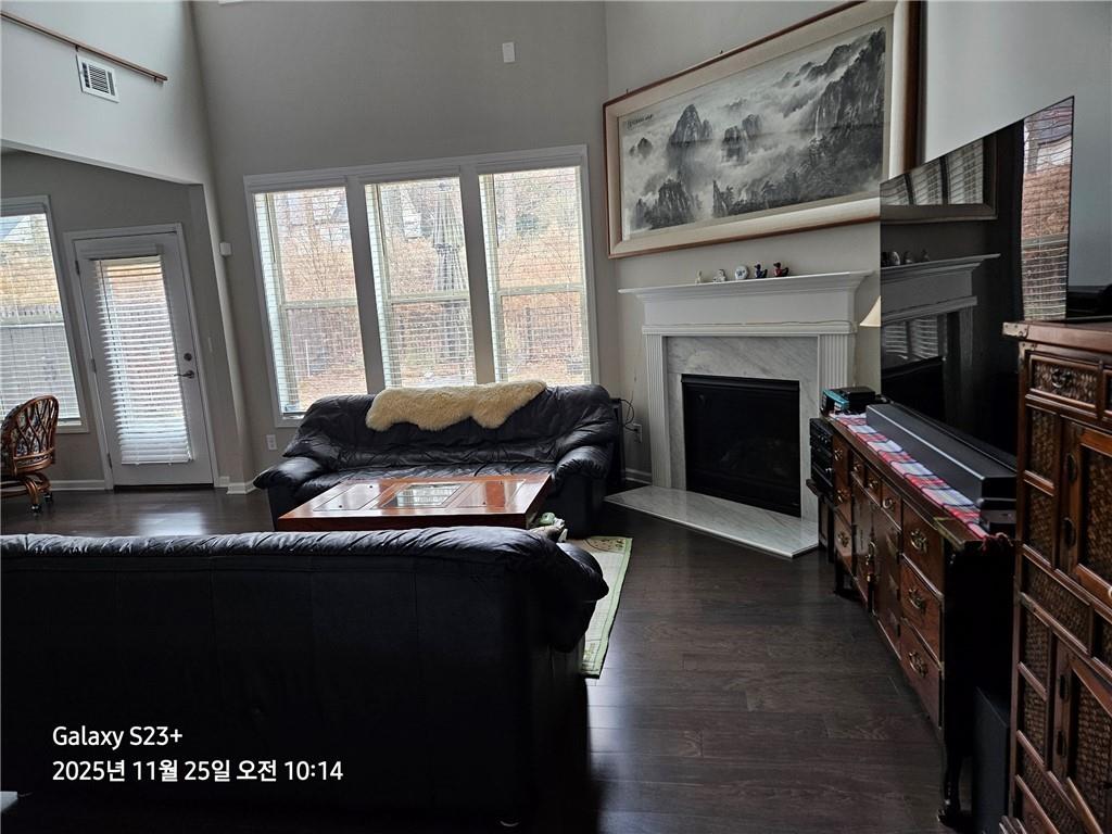 1909 Lakeview Bend Way Buford, GA 30519 - Photo 17 of 30 a living room with furniture a flat screen tv and a fireplace
