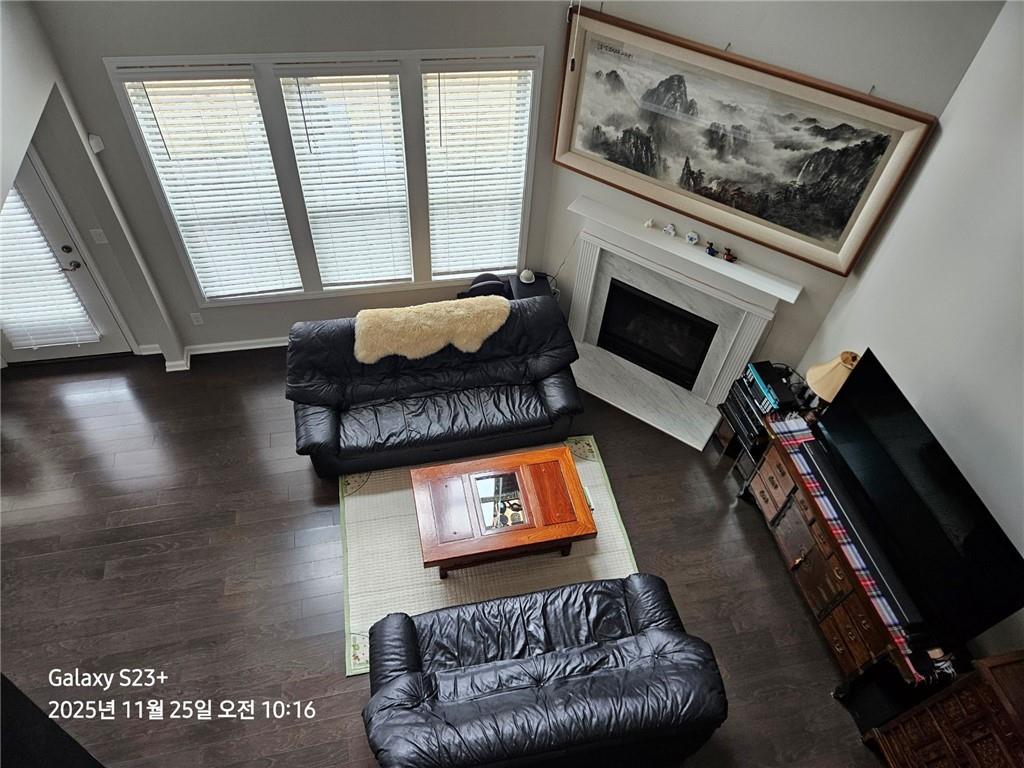 1909 Lakeview Bend Way Buford, GA 30519 - Photo 18 of 30 a living room with furniture a flat screen tv and a fireplace