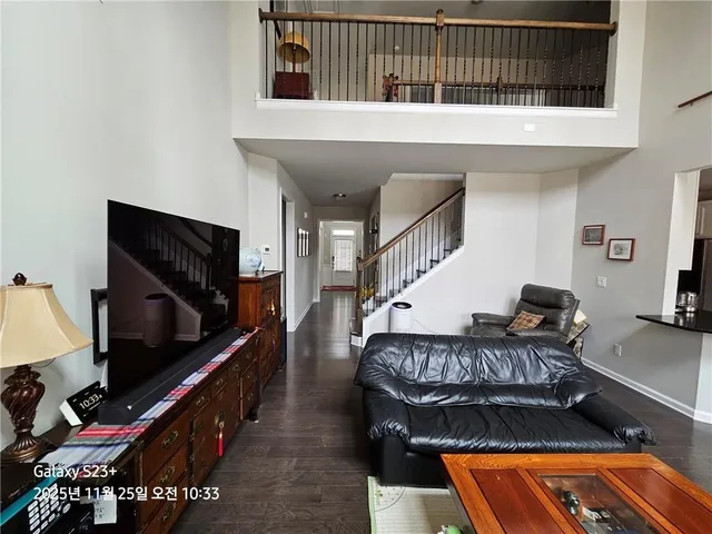 a living room with furniture pool equipment and flat screen tv