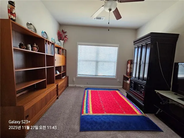 a room with pool table and window