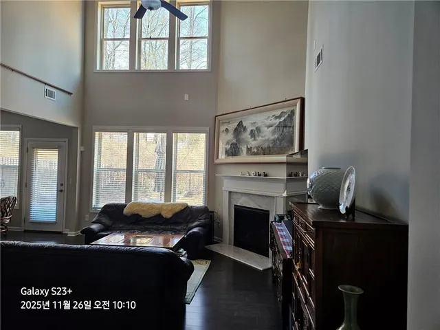 a living room with furniture a fireplace and windows