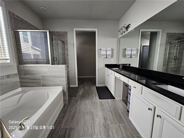 a kitchen with granite countertop a sink and a refrigerator