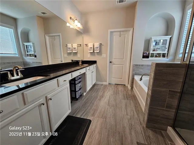 a large kitchen with a sink and refrigerator