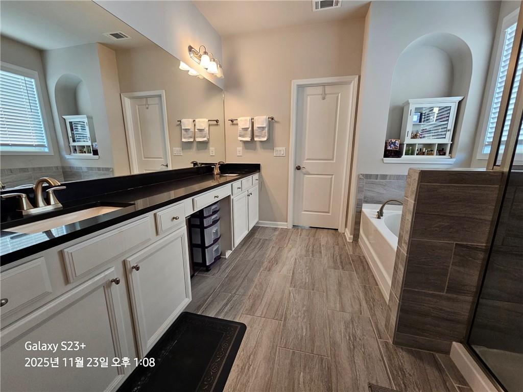 1909 Lakeview Bend Way Buford, GA 30519 - Photo 7 of 30 a large kitchen with a sink and refrigerator