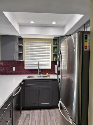 a kitchen with stainless steel appliances granite countertop a sink and cabinets