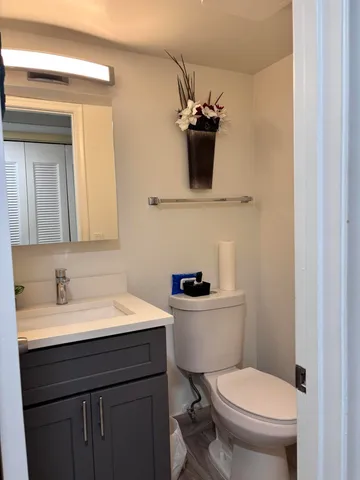 a bathroom with a toilet sink and mirror
