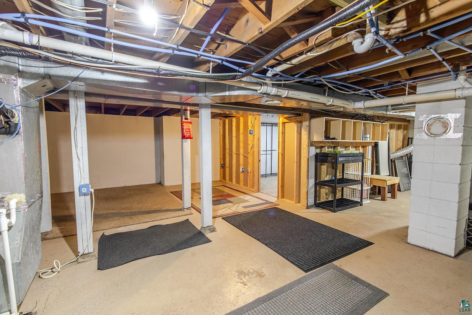 7045 Morris Thomas Road Cloquet, MN 55720 - Photo 21 of 28 Unfinished basement featuring exposed ceiling joists, concrete flooring, and partial wall framing