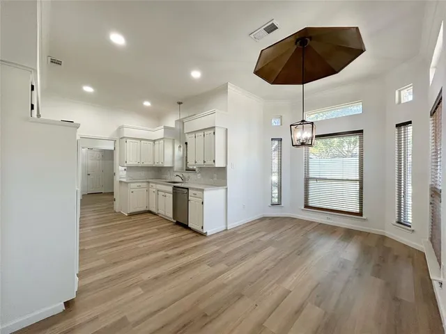 a view of a kitchen with wooden floor
