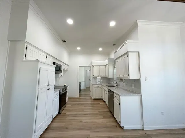 a kitchen with stainless steel appliances granite countertop a stove and a refrigerator