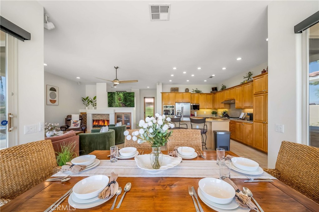 80305 Cedar Crest La Quinta, CA 92253 - Photo 17 of 26 a dining room with furniture a rug and kitchen view