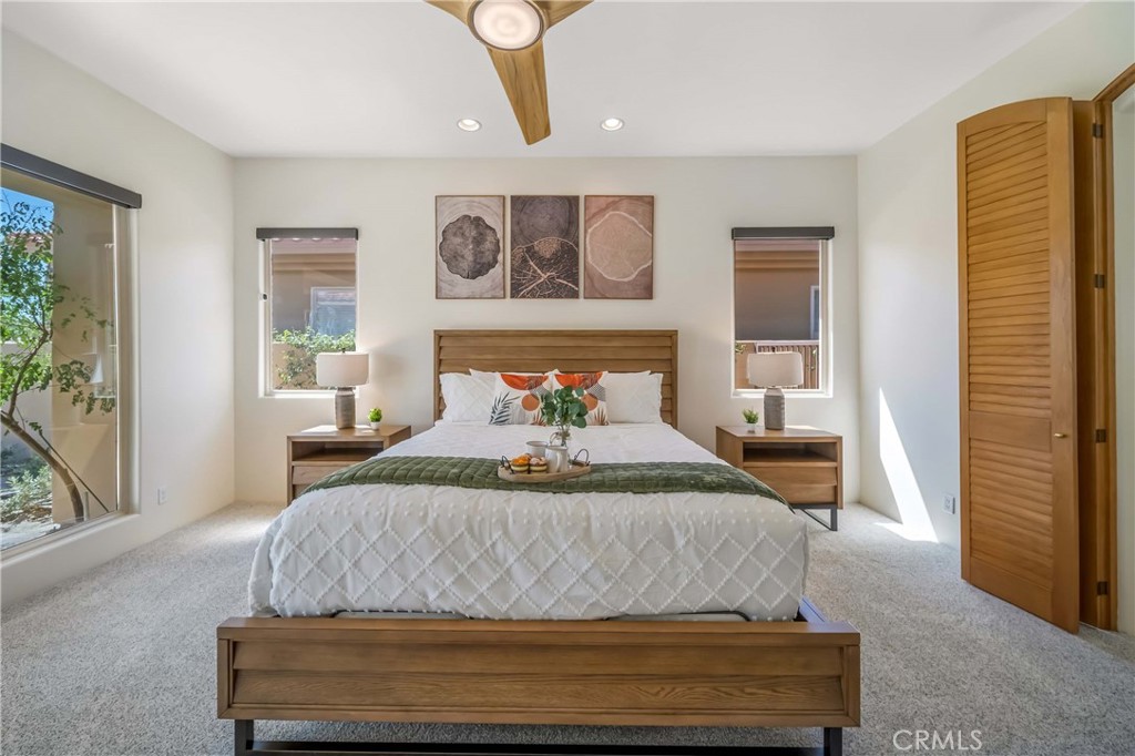 80305 Cedar Crest La Quinta, CA 92253 - Photo 19 of 26 a bedroom with a bed and wooden floor