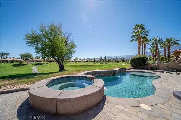 a view of a swimming pool and a yard