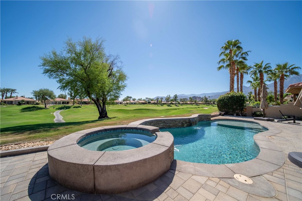 80305 Cedar Crest La Quinta, CA 92253 - Photo 2 of 26 a view of a swimming pool and a yard