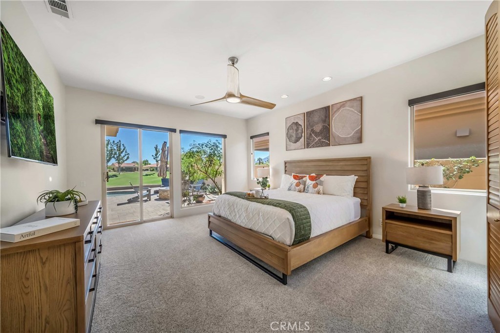 80305 Cedar Crest La Quinta, CA 92253 - Photo 21 of 26 a spacious bedroom with a bed and a couch