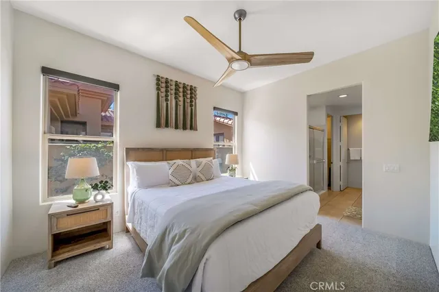 a bedroom with a bed a dresser and a window