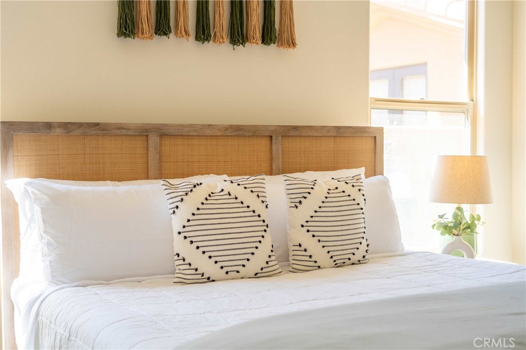 80305 Cedar Crest La Quinta, CA 92253 - Photo 26 of 26 a bedroom with a bed and a night stand with potted plant