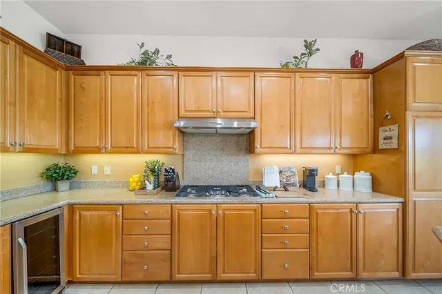 a kitchen with granite countertop wooden cabinets and a sink