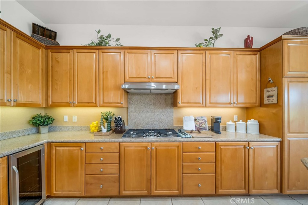 80305 Cedar Crest La Quinta, CA 92253 - Photo 7 of 26 a kitchen with granite countertop wooden cabinets and a sink