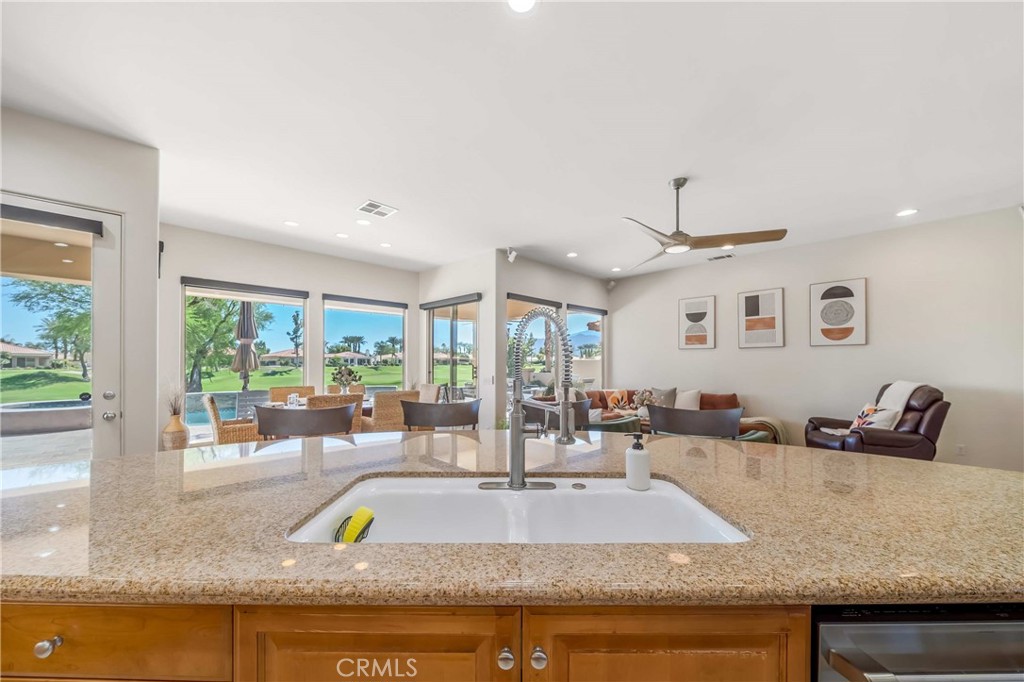 80305 Cedar Crest La Quinta, CA 92253 - Photo 8 of 26 a kitchen with granite countertop a sink and a large window