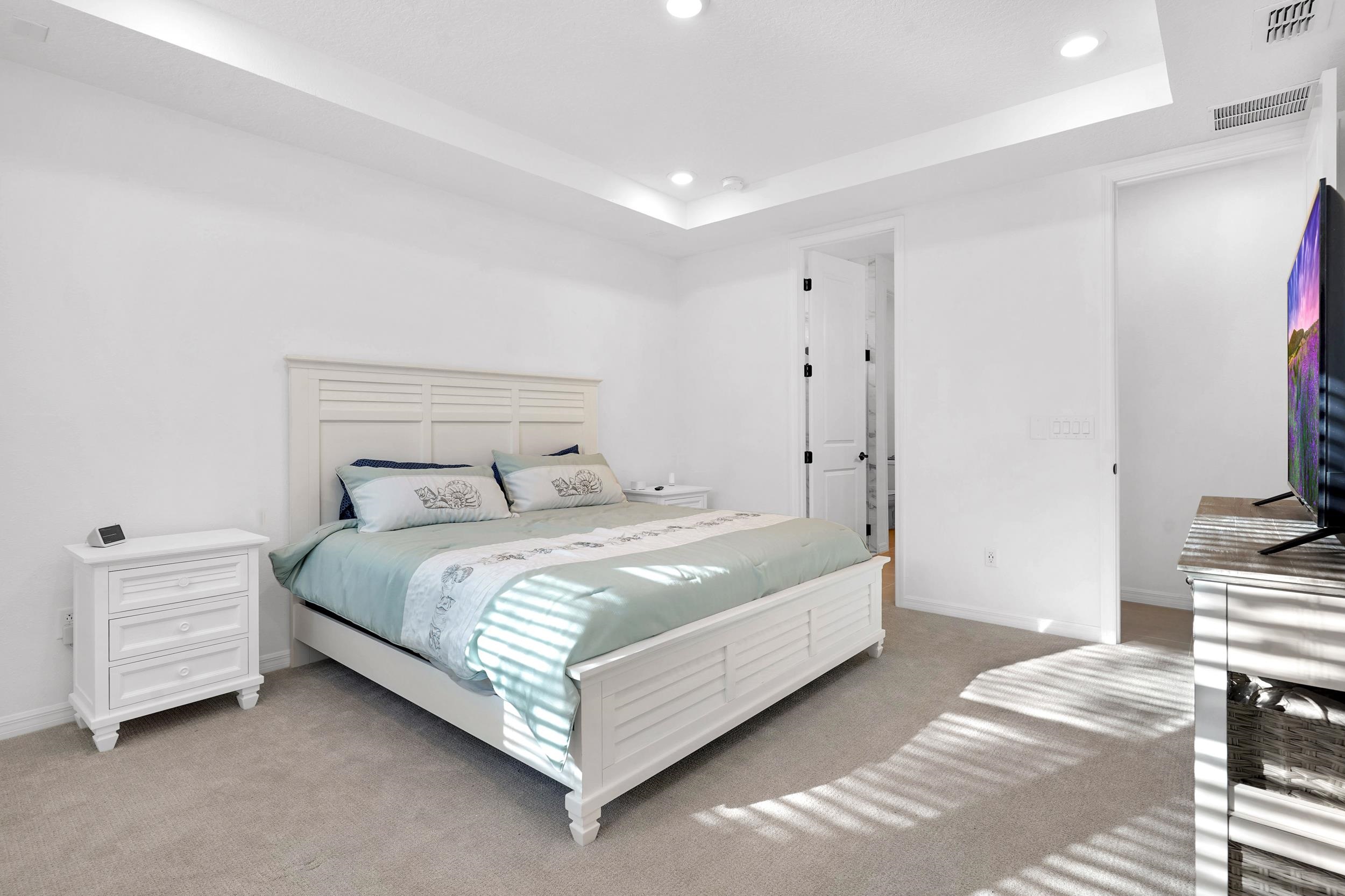 127 Shell Crk Court St. Augustine, FL 32086 - Photo 14 of 38 a bedroom with a bed and a flat screen tv