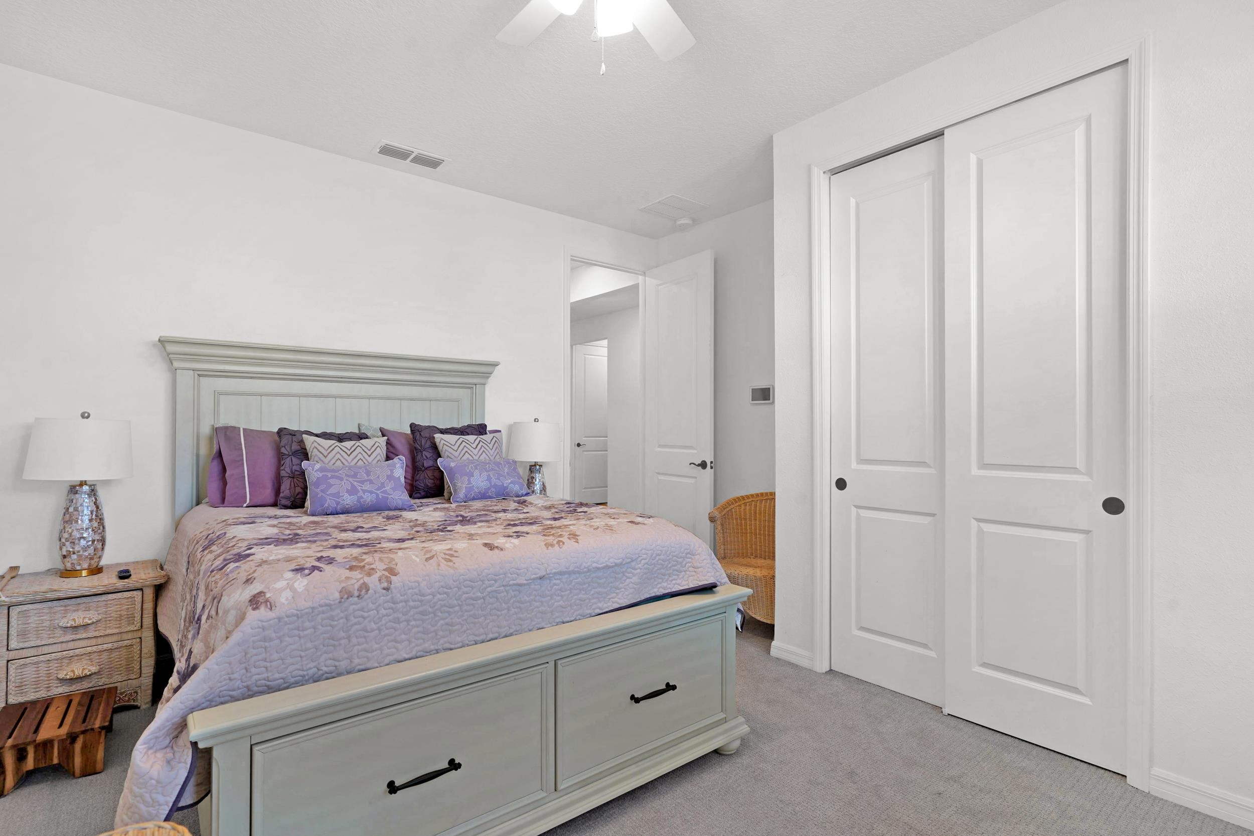 127 Shell Crk Court St. Augustine, FL 32086 - Photo 24 of 38 a bedroom with a bed and a chandelier