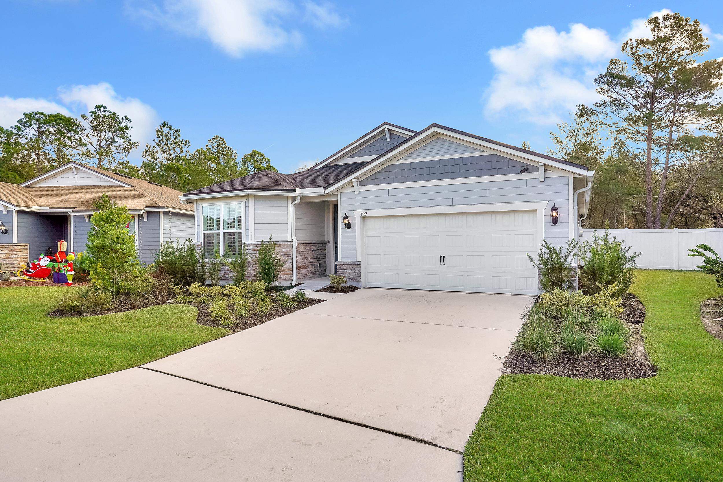127 Shell Crk Court St. Augustine, FL 32086 - Photo 33 of 38 a front view of a house with a yard and garage