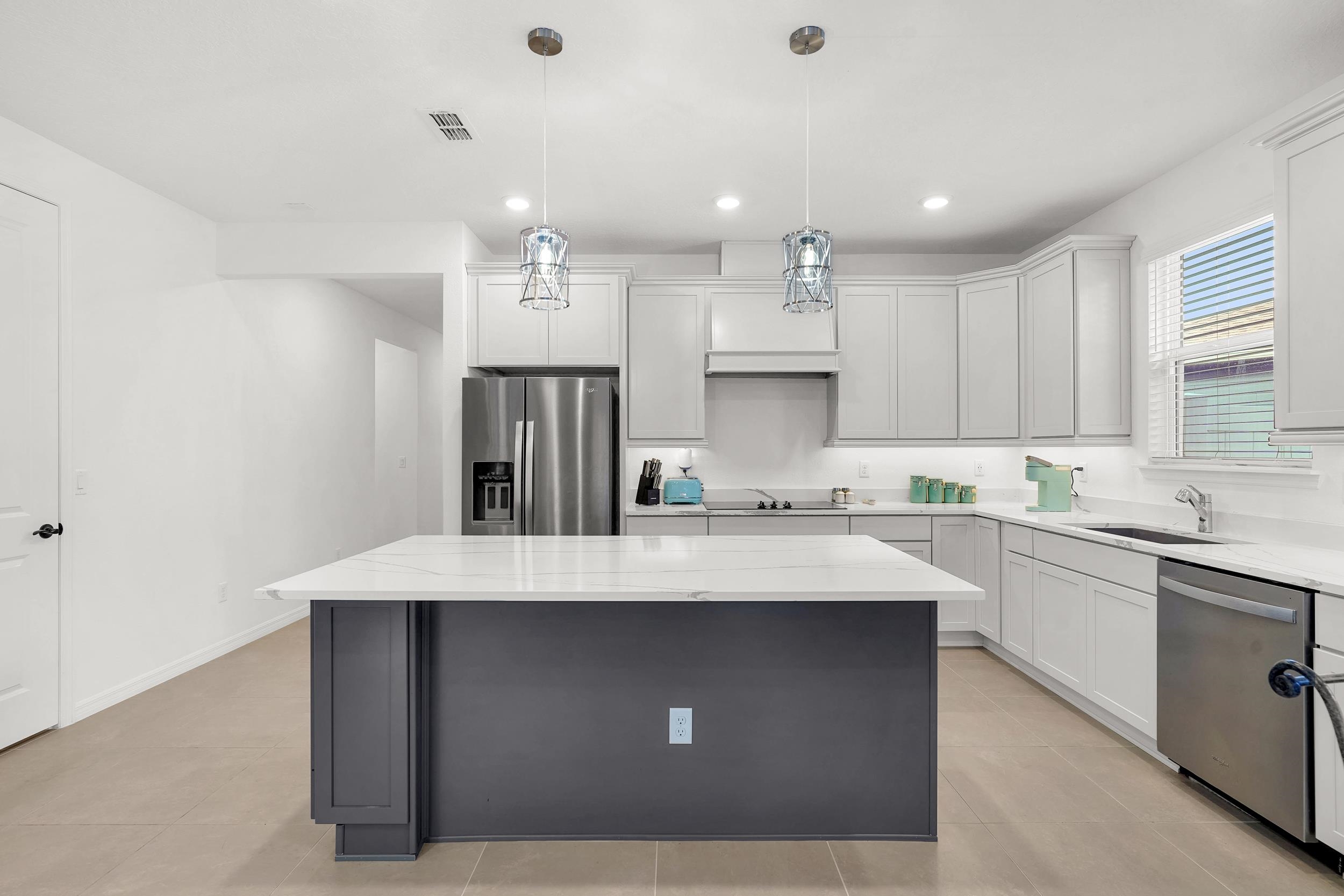 127 Shell Crk Court St. Augustine, FL 32086 - Photo 9 of 38 a kitchen with kitchen island a sink stainless steel appliances and cabinets