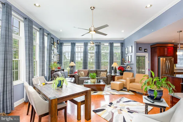 a living room with furniture a chandelier and a dining table