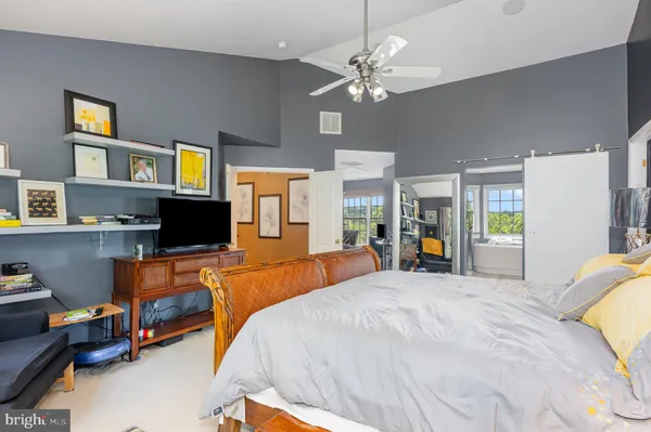 a bed room with a bed and a television