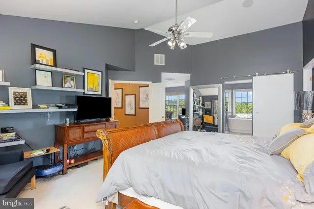 a bed room with a bed and a television