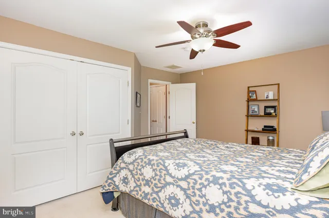 a bedroom with a bed and a ceiling fan
