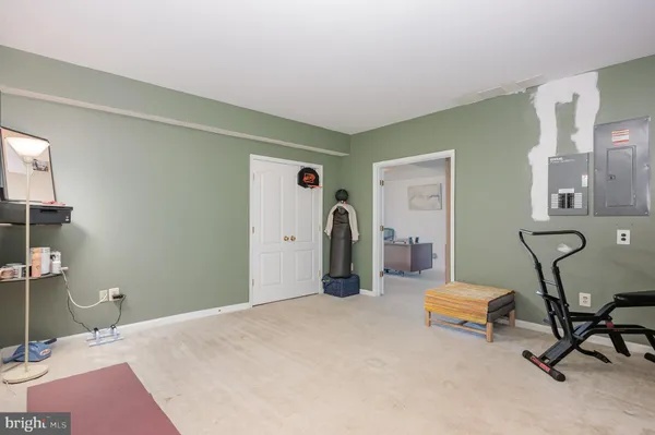 a bedroom with furniture and a air conditioner vent