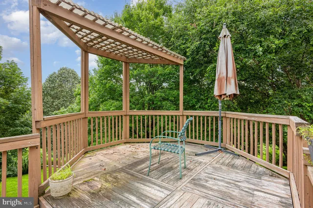 a view of balcony with wooden floor and outdoor seating