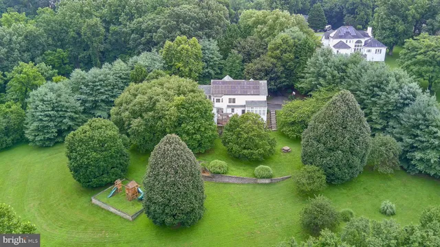 an aerial view of a house with a yard