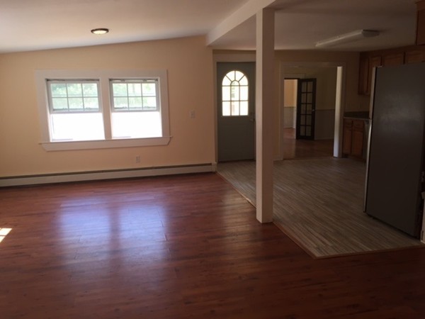 25 Walnut Hill Road Sandown, NH 03873 - Photo 6 of 29 an empty room with wooden floor and windows