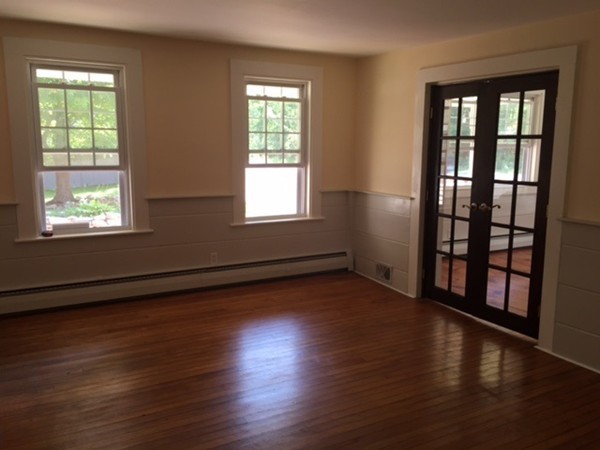 25 Walnut Hill Road Sandown, NH 03873 - Photo 10 of 29 a view of an empty room with wooden floor and a window