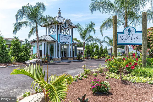 a sign that is sitting in front of flowers