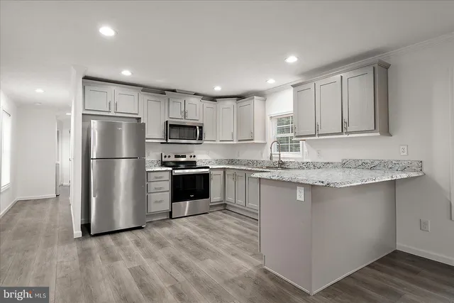 a kitchen with wooden cabinets and stainless steel appliances