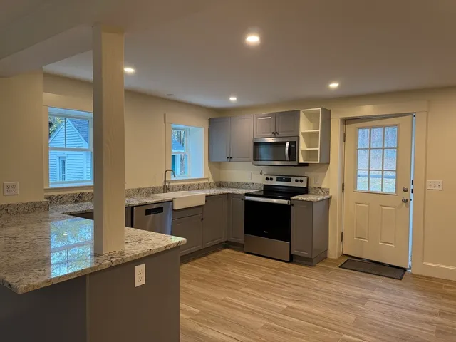 a kitchen with granite countertop stainless steel appliances and sink