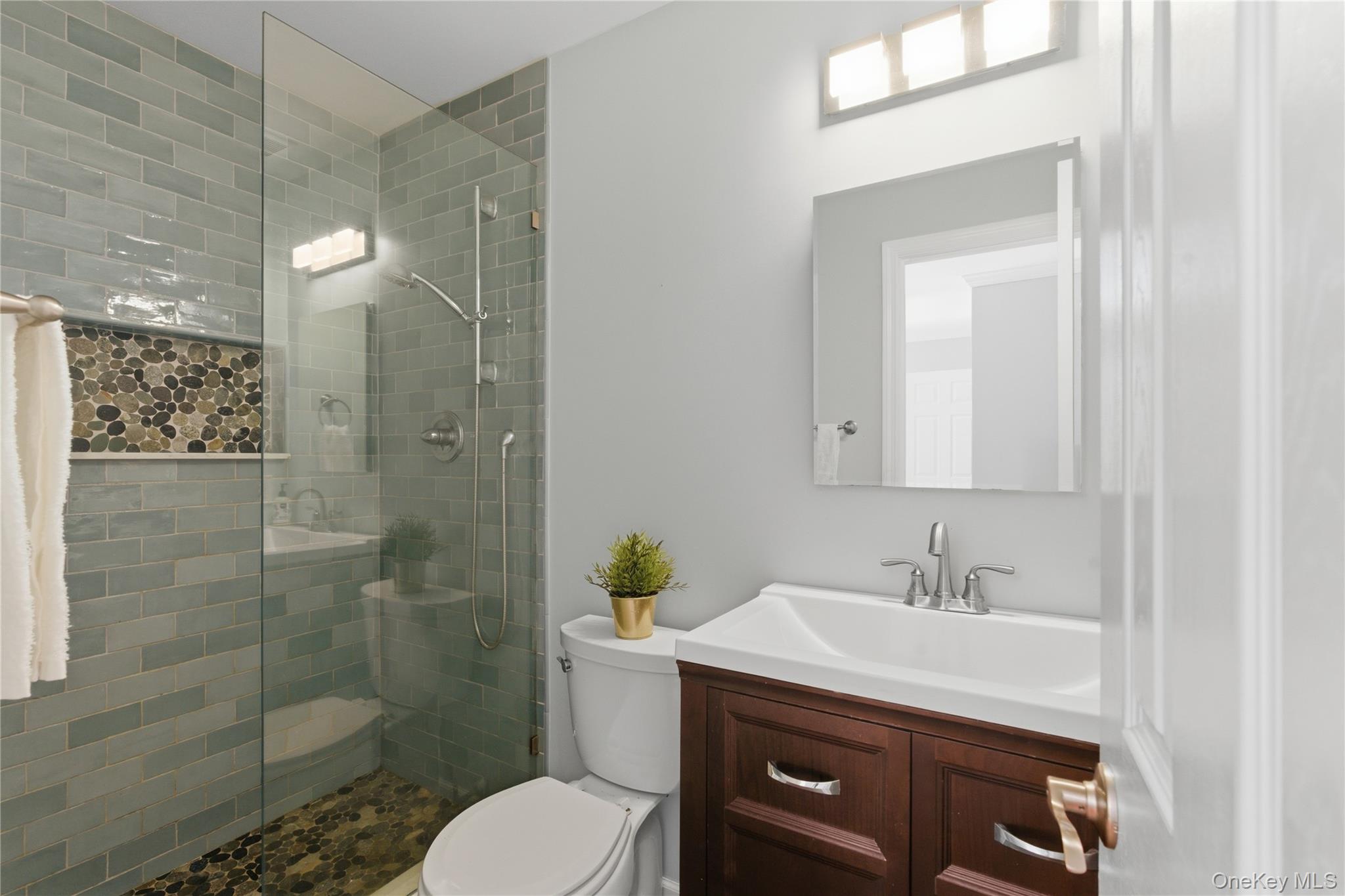 245 Tree Top Crescent Rye Brook, NY 10573 - Photo 12 of 24 a bathroom with a sink toilet and shower