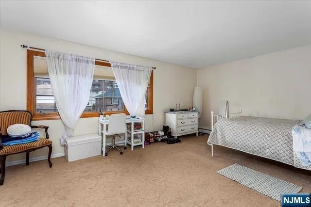 a bedroom with bed and a window