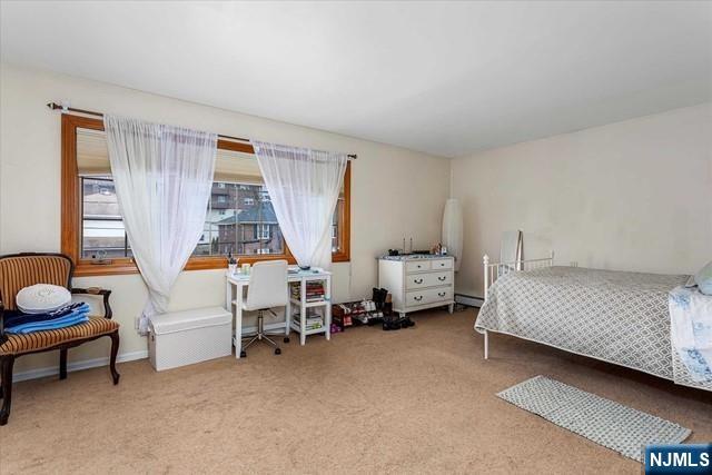 1519 10th Street, Unit 2 Fort Lee, NJ 07024 - Photo 9 of 10 a bedroom with bed and a window