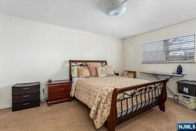 a bedroom with a bed and a tv