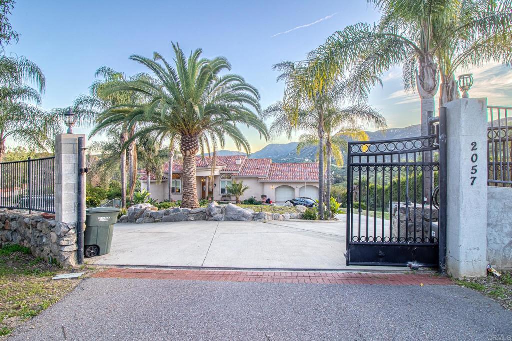 2057 Via Rancho Parkway Escondido, CA 92029 - Photo 2 of 56 a view of a palm trees front of a house