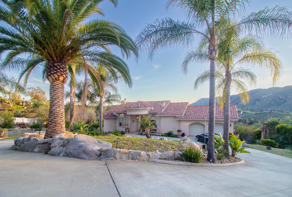 2057 Via Rancho Parkway Escondido, CA 92029 - Photo 3 of 56 a front view of multiple houses with a yard and palm trees