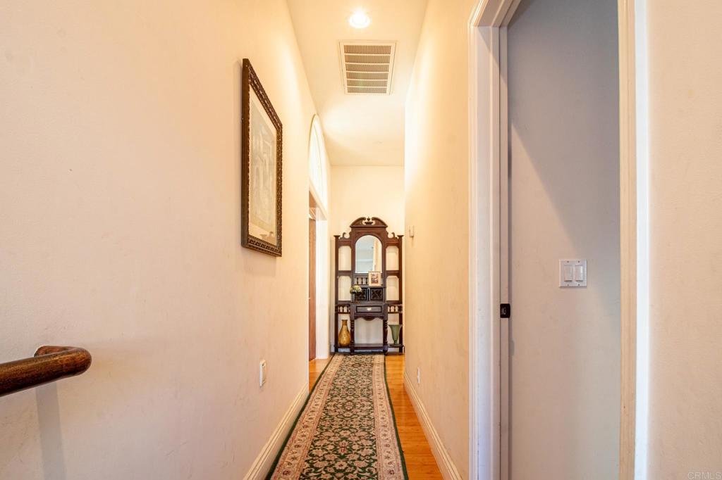 2057 Via Rancho Parkway Escondido, CA 92029 - Photo 39 of 56 a view of a hallway with wooden floor and staircase